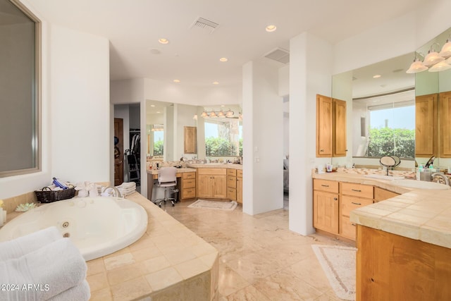 bathroom featuring vanity and a relaxing tiled tub