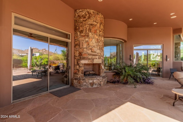 living room featuring an outdoor stone fireplace