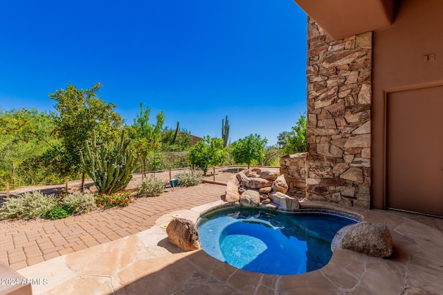 view of pool with an in ground hot tub and a patio area