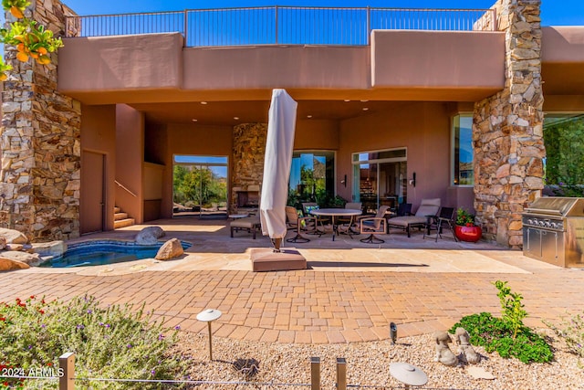 rear view of property featuring a patio area