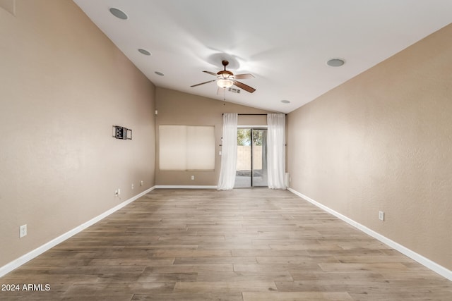 spare room featuring light wood-type flooring, ceiling fan, and lofted ceiling