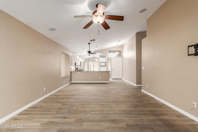 unfurnished living room with ceiling fan, light hardwood / wood-style flooring, and lofted ceiling