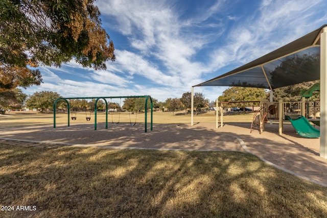 view of home's community with a playground and a lawn