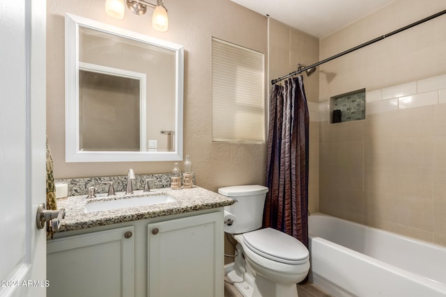 full bathroom featuring shower / tub combo with curtain, vanity, and toilet