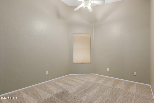 carpeted spare room with ceiling fan