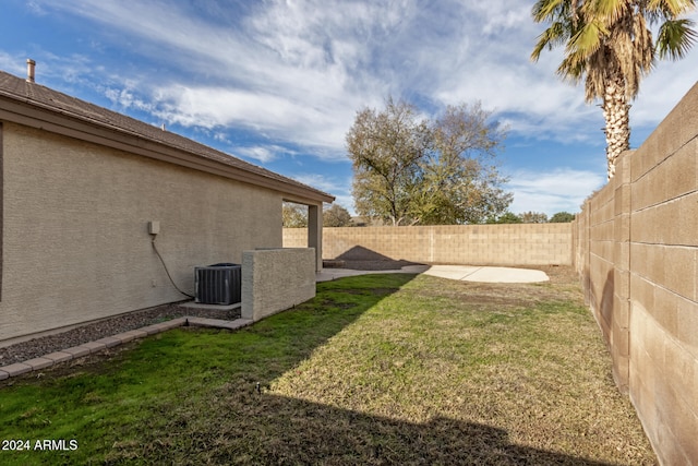 view of yard with a patio and central AC unit