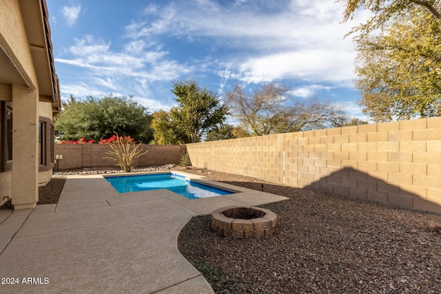 view of pool with a fire pit and a patio area