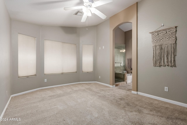 carpeted empty room featuring ceiling fan