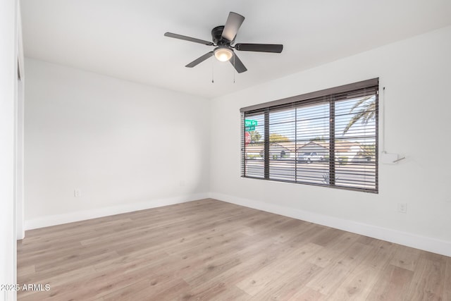 spare room featuring ceiling fan and light hardwood / wood-style flooring