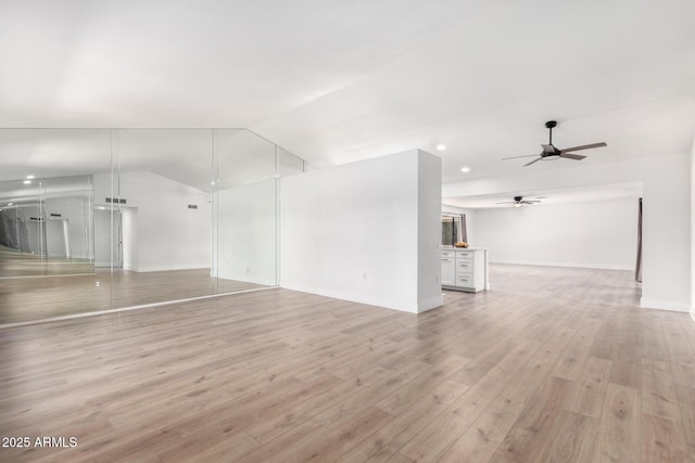 unfurnished living room featuring ceiling fan, light hardwood / wood-style flooring, and lofted ceiling