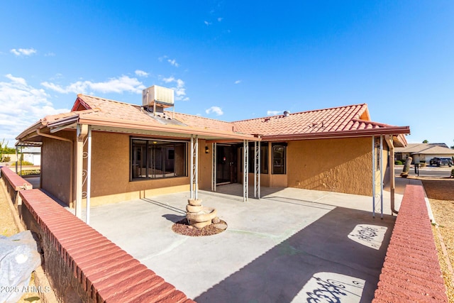 rear view of property featuring a patio