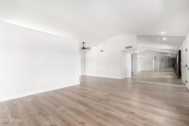 unfurnished living room with ceiling fan, light hardwood / wood-style flooring, and vaulted ceiling