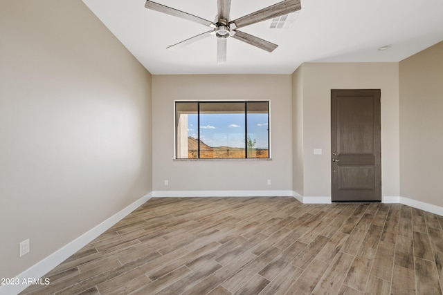 spare room with ceiling fan and hardwood / wood-style floors