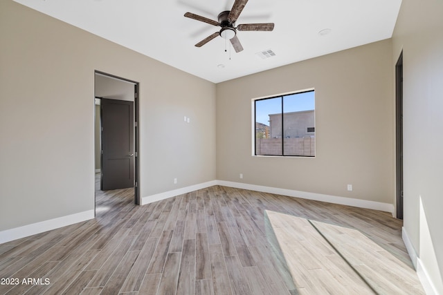 empty room with ceiling fan and light hardwood / wood-style floors