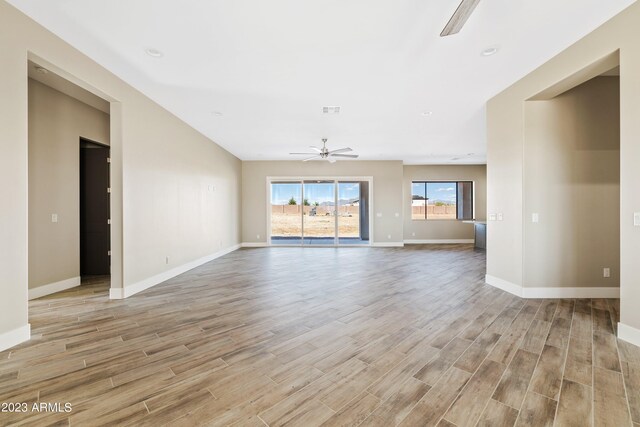 unfurnished living room featuring light hardwood / wood-style flooring and ceiling fan