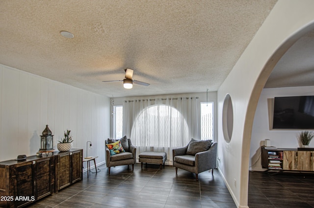 1340 E Townley Ave, Phoenix, AZ 85020 - living area featuring ceiling fan, arched walkways, and a textured ceiling