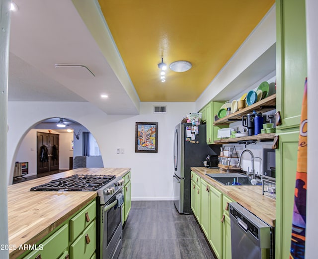 1340 E Townley Ave, Phoenix, AZ 85020 - kitchen featuring butcher block counters, green cabinets, appliances with stainless steel finishes, and arched walkways