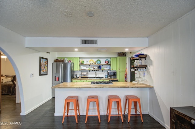 1340 E Townley Ave, Phoenix, AZ 85020 - kitchen with green cabinets, open shelves, stainless steel appliances, wood counters, and arched walkways