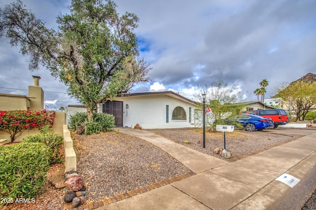 ranch-style house with stucco siding