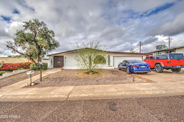 1340 E Townley Ave, Phoenix, AZ 85020 - ranch-style home featuring a garage, driveway, and stucco siding