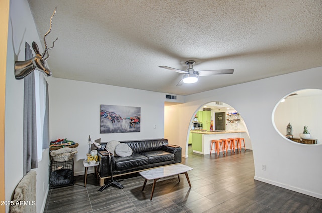 1340 E Townley Ave, Phoenix, AZ 85020 - living area featuring a ceiling fan, arched walkways, and a textured ceiling