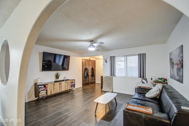 1340 E Townley Ave, Phoenix, AZ 85020 - living room with a textured ceiling, a ceiling fan, and arched walkways