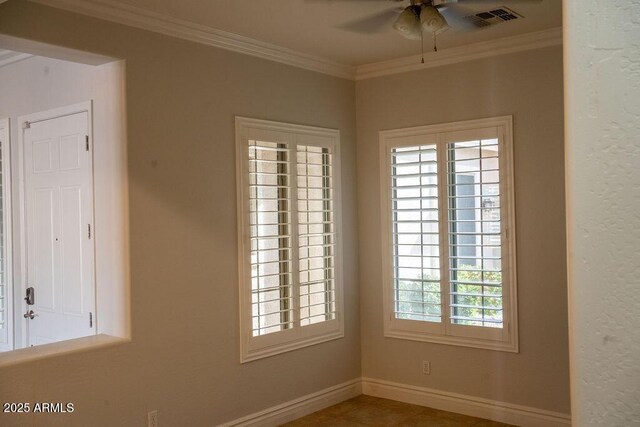 empty room featuring crown molding and ceiling fan