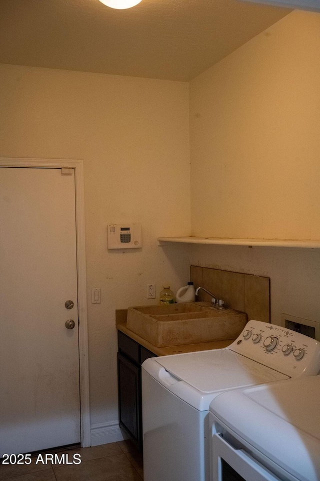 washroom with independent washer and dryer, cabinets, tile patterned flooring, and sink