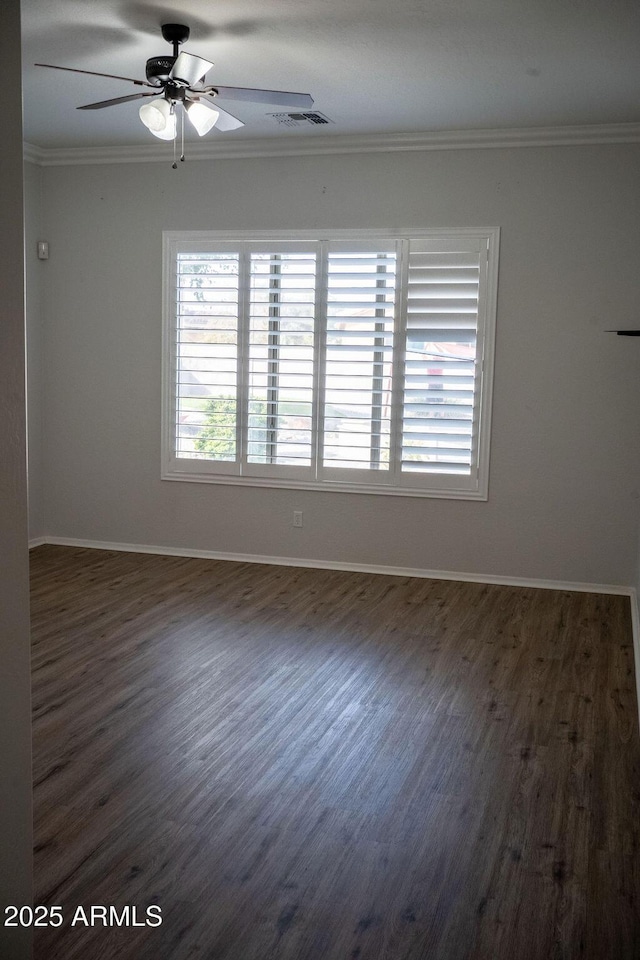 spare room with ornamental molding, ceiling fan, and dark hardwood / wood-style flooring