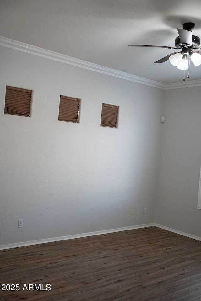 spare room featuring crown molding, dark hardwood / wood-style floors, and ceiling fan