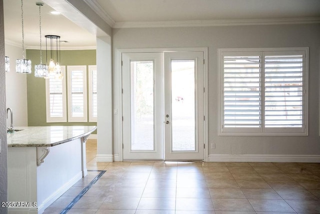 doorway featuring light tile patterned flooring, sink, crown molding, an inviting chandelier, and french doors