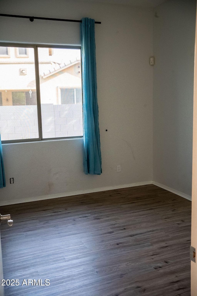 unfurnished room with dark hardwood / wood-style flooring