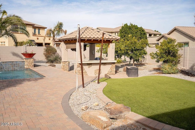 view of yard with pool water feature, a gazebo, a fenced in pool, and a patio area