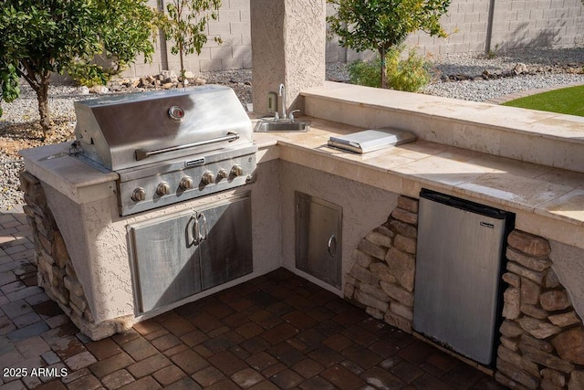 view of patio / terrace with a grill, area for grilling, and sink