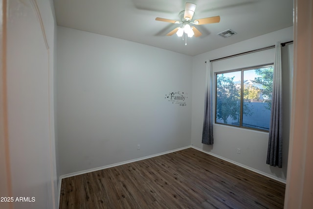 empty room with dark wood-type flooring and ceiling fan