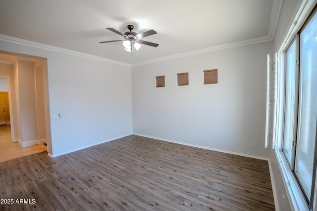 empty room with hardwood / wood-style flooring, ceiling fan, ornamental molding, and a healthy amount of sunlight