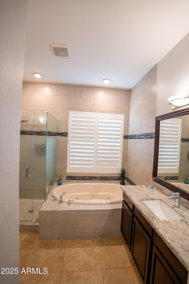 bathroom featuring tile patterned flooring, vanity, and independent shower and bath