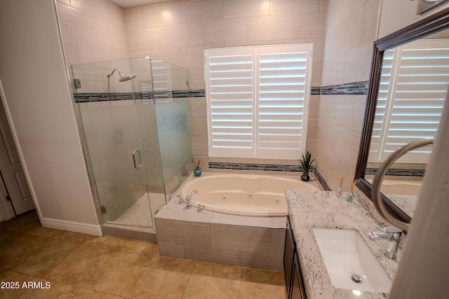 bathroom featuring vanity, plus walk in shower, and tile patterned flooring