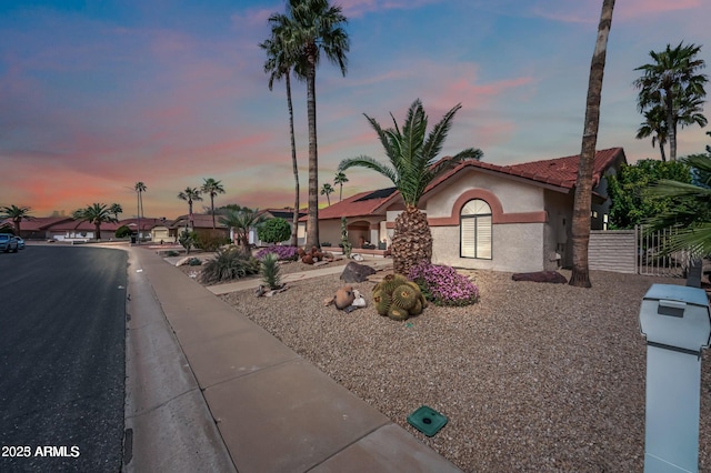 view of front of property featuring stucco siding and a tiled roof