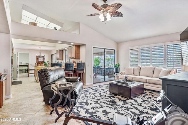 living area with lofted ceiling, light tile patterned floors, ceiling fan with notable chandelier, and baseboards