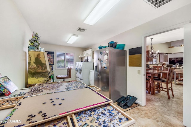 kitchen with fridge, a notable chandelier, stainless steel fridge with ice dispenser, and visible vents