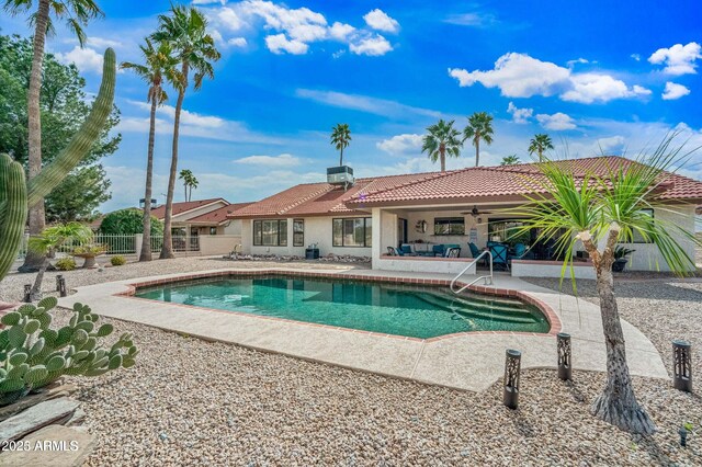 outdoor pool with a patio area, ceiling fan, and fence