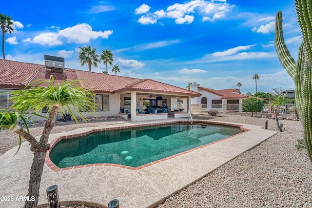 pool featuring a patio, central air condition unit, fence, and ceiling fan