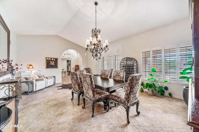 dining space featuring vaulted ceiling, arched walkways, and a chandelier