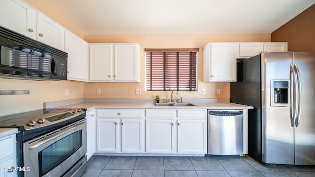 kitchen featuring light countertops, appliances with stainless steel finishes, a sink, and white cabinetry