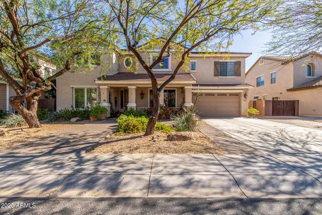 14363 W Acapulco Ln, Surprise, AZ 85379 - view of front facade with concrete driveway, stucco siding, fence, an attached garage, and a porch