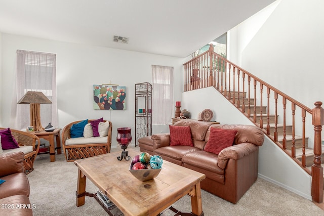 14363 W Acapulco Ln, Surprise, AZ 85379 - living room featuring stairs, visible vents, and light carpet