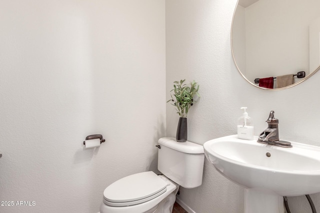 14363 W Acapulco Ln, Surprise, AZ 85379 - half bath with a sink, a textured wall, and toilet