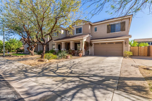 14363 W Acapulco Ln, Surprise, AZ 85379 - view of front of property with a tile roof, concrete driveway, stucco siding, fence, and a garage
