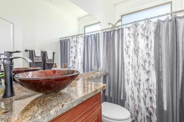 14363 W Acapulco Ln, Surprise, AZ 85379 - full bathroom with toilet, vanity, and a shower with shower curtain